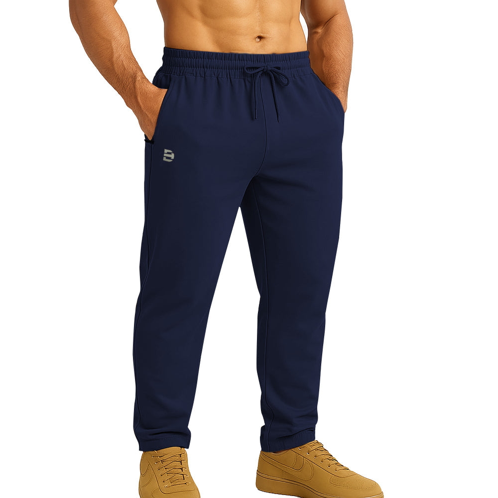Navy blue jogger pants worn by a person on a white background