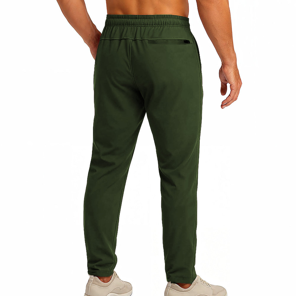 Green athletic pants worn by a person on a white background