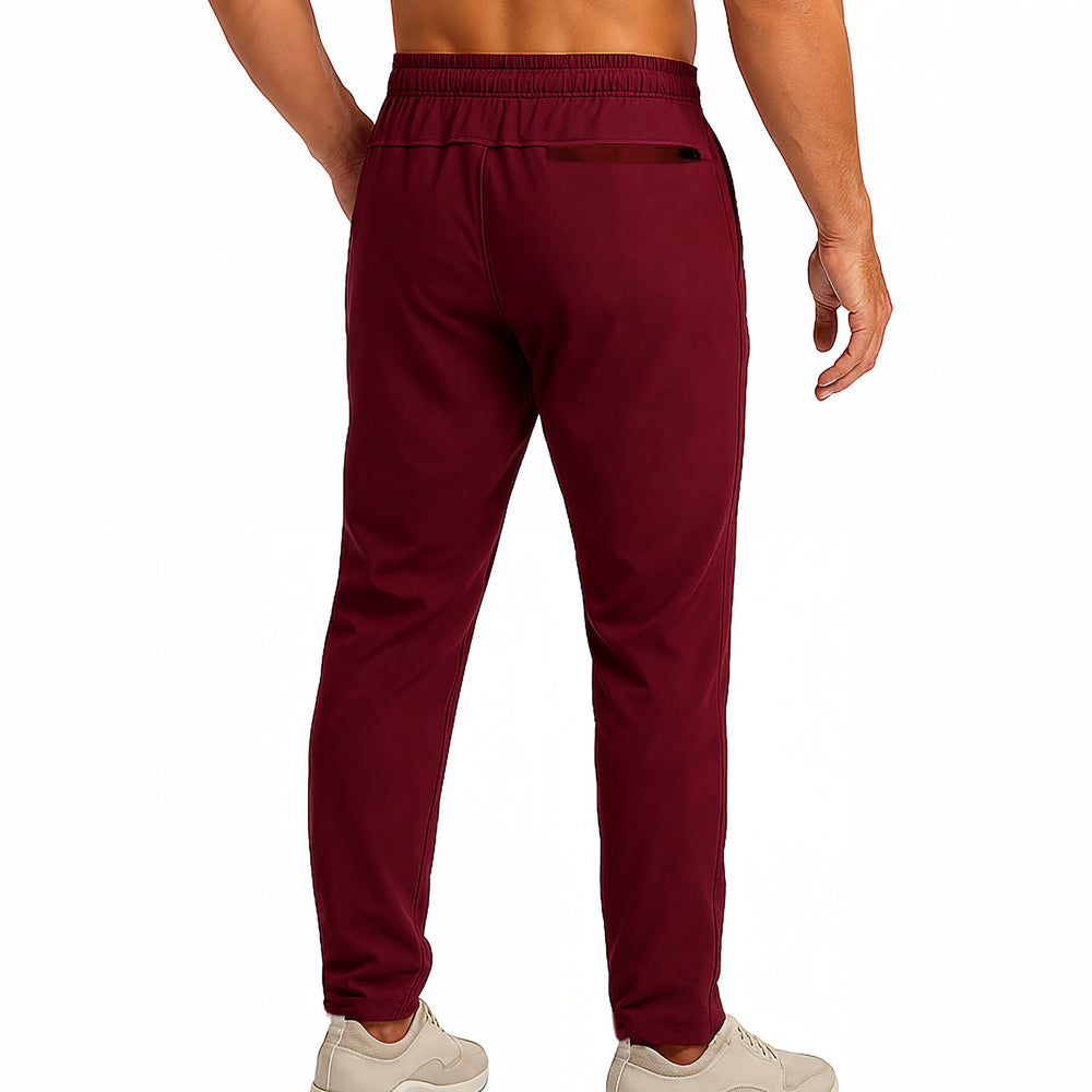 Maroon sweatpants worn by a person on a white background